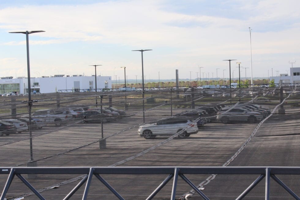 Hail canopy working around pre existing poles — Parking Lot Hail Protection